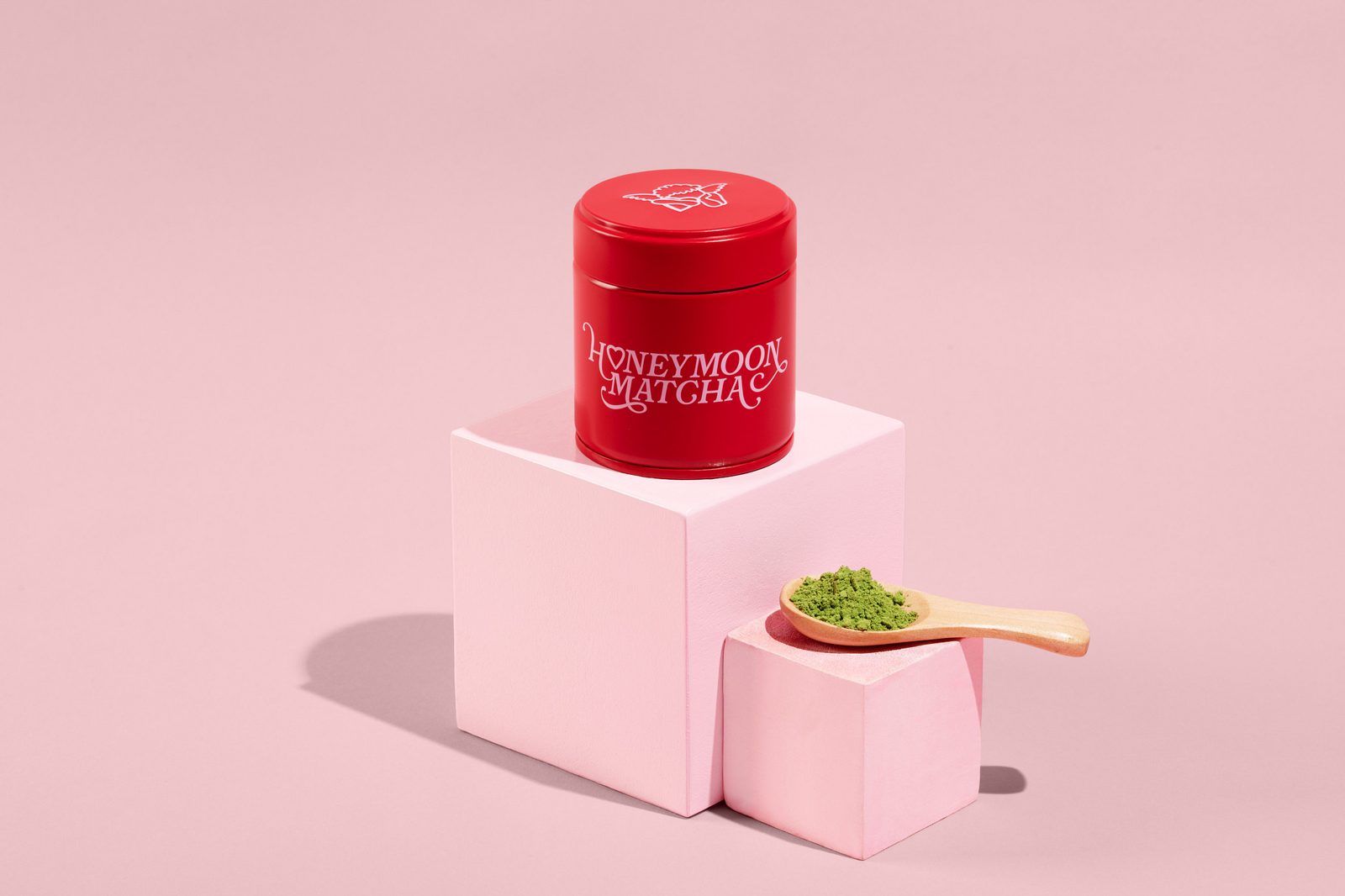 Honeymoon Matcha tin on pink blocks